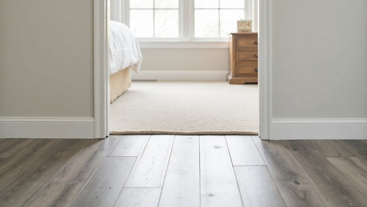 Hallway with vinyl plank flooring transitioning into a bedroom with carpet flooring